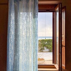 a window with a view of the beach at Edo House Anzio - Beachfront - Fronte Mare - Affittacamere - Private Parking in Anzio