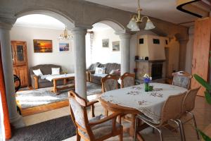 a living room with a table and a couch at Júlia Apartman in Balatonalmádi