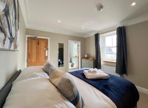 a bedroom with a bed with two towels on it at St Michaels Reach Guest House in Marazion