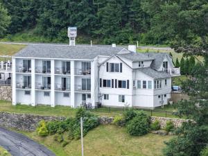 an aerial view of a large white house at Belknap Point Inn in Gilford