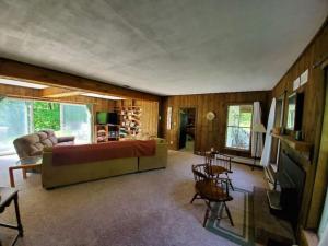 a living room with a couch and a tv at Vermont Escape, Too in Warren
