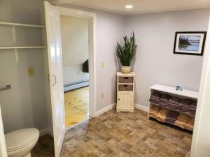 a bathroom with a toilet and a plant on the wall at Vermont Escape, Too in Warren +42 photos