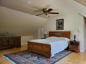 a bedroom with a bed and a ceiling fan at Vermont Escape, Too in Warren