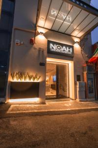 a natal store with a sign on the side of a building at Noah Gate Hotel & Suites in Naples