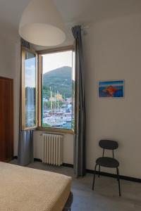 a bedroom with a window with a view of a marina at Albergo NARDINI in Le Grazie +30 photos