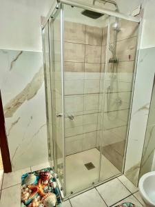 a shower with a glass door in a bathroom at Civico 31 in Terralba +21 photos