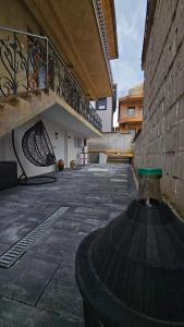 a building with a vase on the ground in a courtyard at Lex Apartments KS in Prizren