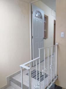 a staircase with a white door in a house at Casa Verano in Guanajuato