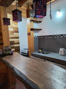 a kitchen with a wooden counter top and a sink at Cabaña Padilla in Tilcara