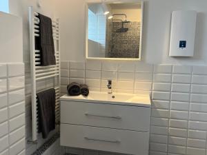 a white bathroom with a sink and a mirror at Justs Place in Garding