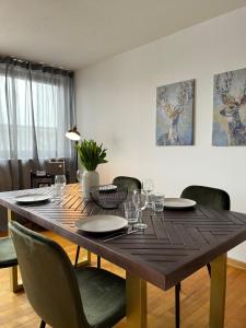 a dining room table with chairs and a large wooden table at Justs Place in Garding +18 photos