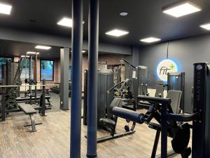 a gym with treadmills and machines in a room at Justs Place in Garding