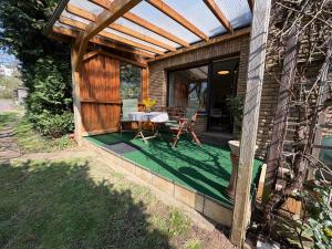 a wooden patio with a table and a table at Ferienwohnung Löffel-Lodge in Heimbach