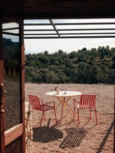 a table and two chairs and a table and chairs at Habitació EL GRANER in Rasquera
