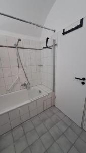 a bathroom with a shower and a bath tub at Amtsstube1892 - Übernachten im alten Gefängnis in Überlingen