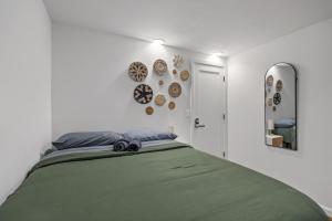 a bedroom with a green bed and plates on the wall at Times Square Heart - The Global Nook - Cozy Private Room in New York