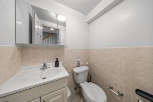 a bathroom with a toilet and a sink and a mirror at Times Square Heart - The Global Nook - Cozy Private Room in New York