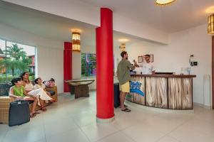 a man ordering food at a counter in a restaurant at Capoeira Village in Porto Seguro +84 photos