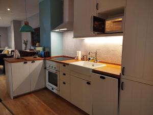 a kitchen with white cabinets and a sink at R2R - Apartamento cerca del mar - 14A12 in Lastres