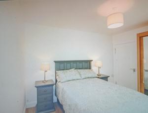 a bedroom with a bed and two lamps on night stands at Countryside bliss in Clonakilty
