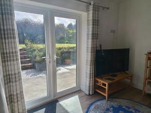 a living room with a sliding glass door with a view at Countryside bliss in Clonakilty
