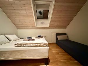 a small bedroom with a bed and a window at Apartments with Panoramic Views in Longyearbyen