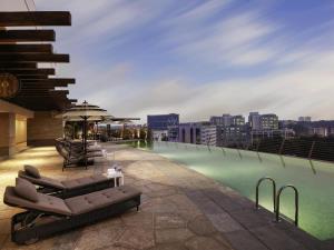 a swimming pool on the roof of a building at Novotel Kochi Infopark in Cochin