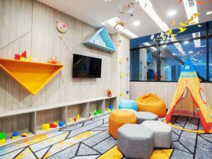 a childrens play room with a slide and play equipment at ibis Styles Medan Pattimura in Medan