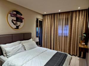 a bedroom with a large bed and a clock on the wall at CaSa FAMILY HOUSE in Casablanca