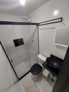 a small bathroom with a toilet and a sink at Pousada Caverna da Praia in Rio de Janeiro