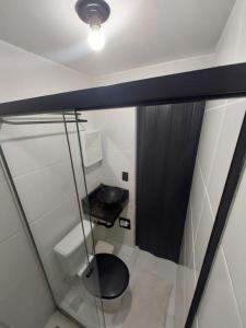 a small bathroom with a toilet and a sink at Pousada Caverna da Praia in Rio de Janeiro