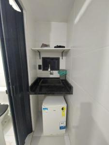 a small kitchen with a sink in a room at Pousada Caverna da Praia in Rio de Janeiro