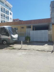 a van parked in a parking lot next to a building at Pousada Caverna da Praia in Rio de Janeiro
