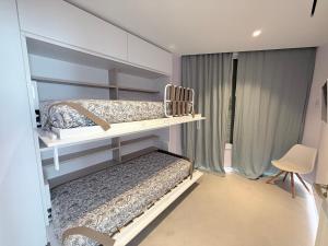 a bedroom with two bunk beds and a window at ALGAIDAMAR BEACH LUXURy in Sitio de Calahonda +84 photos