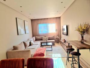 a living room with a couch and a table at CaSa FAMILY HOUSE in Casablanca