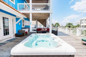 a hot tub on the deck of a house at Paws and Relax! in Carolina Beach