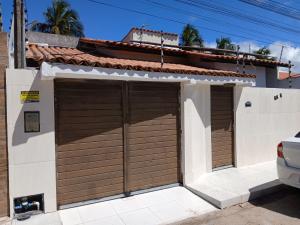 a pair of garage doors on a house at Casa praia de Barra nova 6 km de Maceió in Marechal Deodoro
