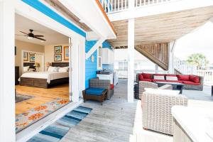 a screened porch with a bed and a living room at Paws and Relax! in Carolina Beach
