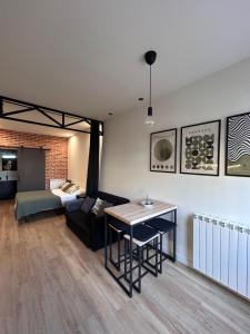 a living room with a couch and a table at Apartamentos Bajo La Viga con Piscina in Salamanca