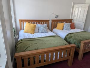two beds sitting next to each other in a room at Affleck Street in Gateshead
