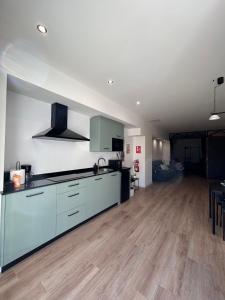 a kitchen with a counter top and a dining room at Apartamentos Bajo La Viga con Piscina in Salamanca