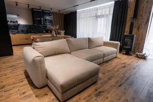 a living room with a couch and a table at GoldHill villas 9 in Yaremche