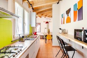a kitchen with a sink and a stove top oven at Dimora Farnese in Piacenza +17 photos