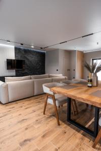 a living room with a table and a couch at GoldHill villas 9 in Yaremche
