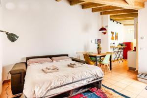 a bedroom with a bed and a table in a room at Dimora Farnese in Piacenza
