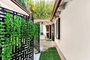 a hallway of a house with green plants at Dimora Farnese in Piacenza