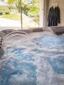 a jacuzzi tub filled with lots of snow at Gîte Chez Claudia in Marsolan