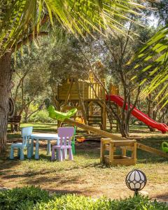 a park with a table and chairs and a playground at Casa Elia Datça in Emecik