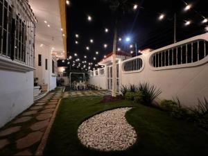 a courtyard of a house at night with lights at Casa Solar Boutique Eco-Hotel in Minatitlán