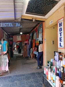 a market with clothes and a person standing in a store at Hotel AEROPUERTO Jujuy in Perico